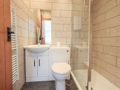 A bathroom featuring a sink, toilet, and shower at Boxwood Cottage in Troutbeck