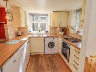 A kitchen with appliances and cabinetry at Boxwood Cottage in Troutbeck