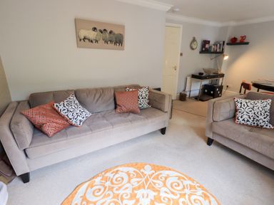 A living room with two sofas and a rug at Ghyll Heights in Ambleside