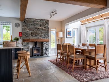 A dining room with a table and chairs at Goody Raise in Grasmere