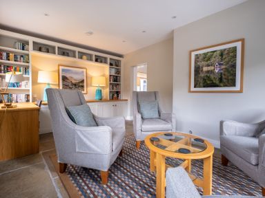 A snug with armchairs and a table at Goody Raise in Grasmere