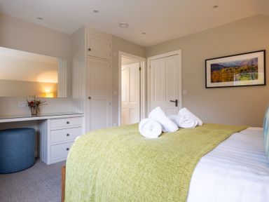 A bedroom with a bed and desk at Goody Raise in Grasmere