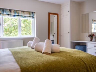 A bedroom with a bed and towels at Goody Raise in Grasmere