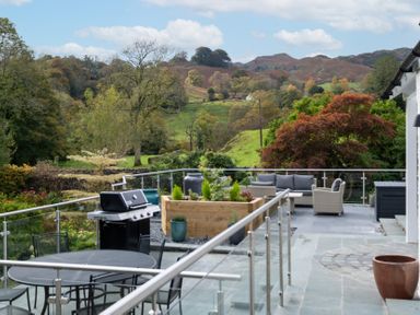 An outdoor area with a grill and seating at Goody Raise in Grasmere