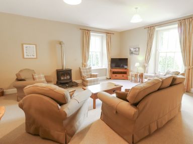 A living room with seating and a television at Hawkshead Hall in Hawkshead