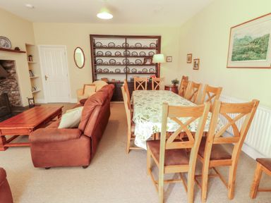 A dining room with a table and chairs at Hawkshead Hall in Hawkshead