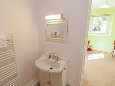 A bathroom with a sink and mirror at Hawkshead Hall in Hawkshead