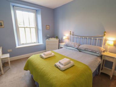 A bedroom with a bed and bedside tables at Hawkshead Hall in Hawkshead