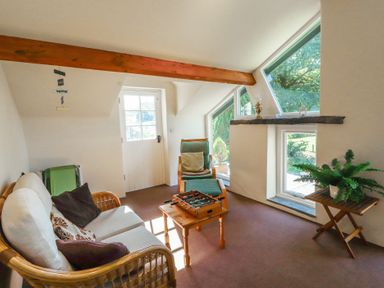 A snug with seating and a board game at Hawkshead Hall in Hawkshead