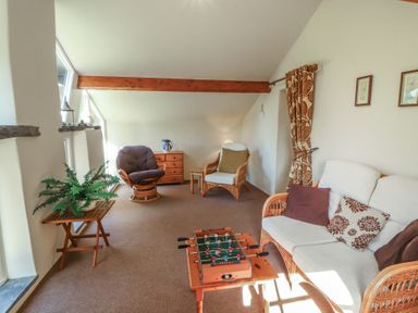 A living room with a sofa and coffee table at Hawkshead Hall in Hawkshead