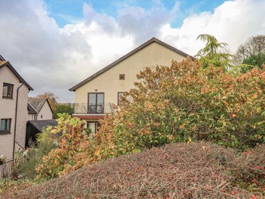 Exterior view of houses with bushes and plants in front at Waterhead Retreat Ambleside