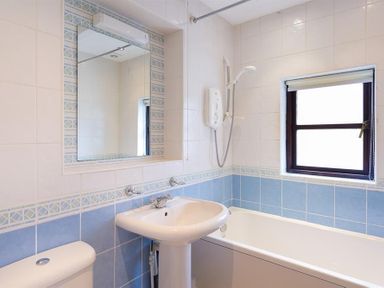 A bathroom with a sink toilet bathtub and a window at Thirlmere Cottage in Grasmere