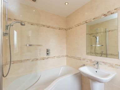 A bathroom with a bathtub shower combination and a sink at Todd Crag in Ambleside