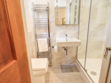 A bathroom with a toilet sink shower and towel rack at Rawfell in Great Langdale