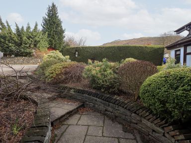 An outdoor area with a pathway and various bushes at Mardale in Ambleside