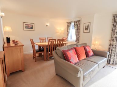 A living room with a sofa and dining area at Mardale in Ambleside