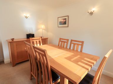 A dining room with a wooden table and chairs at Mardale in Ambleside