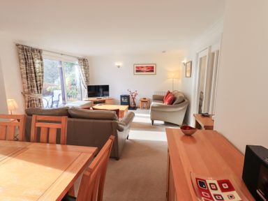 A living room with a television and sofa at Mardale in Ambleside