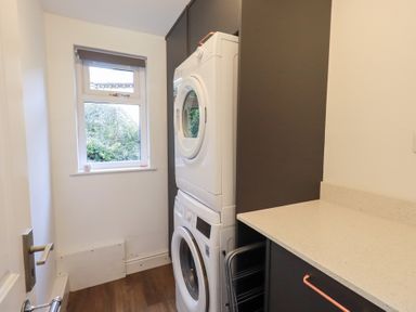 A laundry room with a washing machine and tumble dryer at Mardale in Ambleside