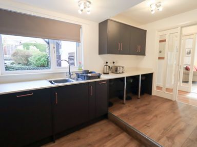 A kitchen with sink, cabinets, and appliances at Mardale in Ambleside