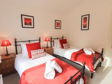 A bedroom with two beds and lamps at Mardale in Ambleside