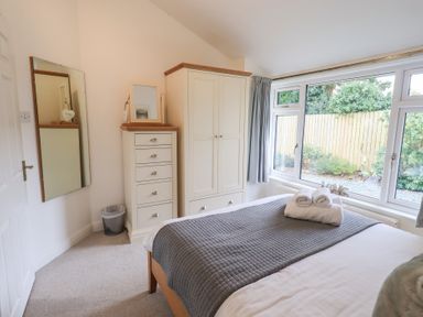 A bedroom with a bed and a wardrobe at Mardale in Ambleside