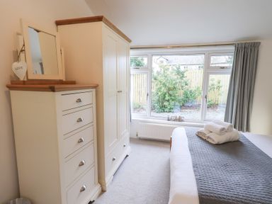 A bedroom with a bed and storage furniture at Mardale in Ambleside