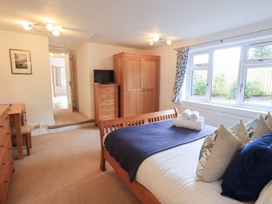 A bedroom with a bed and wardrobe at Mardale in Ambleside