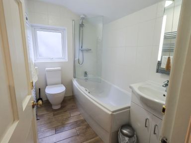 A bathroom with a bathtub and a shower at Chapel Hill Cottage in Ambleside