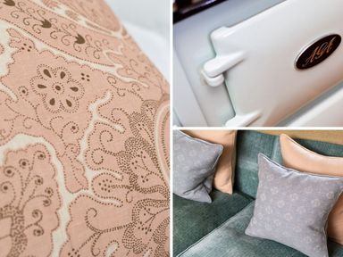 Close up of patterned fabric a white Aga oven door and cushions on a green sofa at High Cunsey Farm Far Sawrey