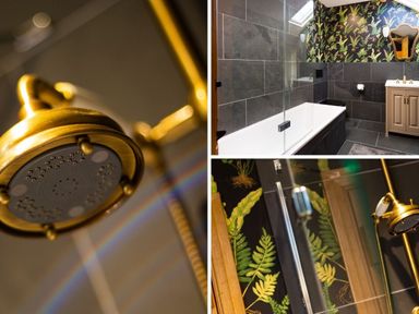 A bathroom with bathtub shower and floral wallpaper at High Cunsey Farm in Far Sawrey