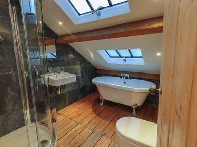 A bathroom with a bathtub a sink a shower and a toilet at Fairy Glen in Grasmere near Ambleside