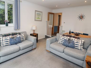 A living room with two grey sofas and blue patterned cushions at Helm Crag in Grasmere