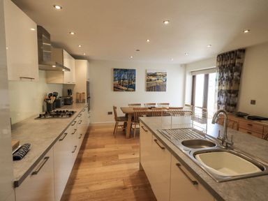 A kitchen with table and chairs at No 7 in Ambleside