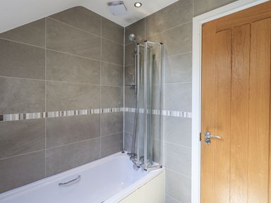 A bathroom with a bathtub and shower at No 7 in Ambleside