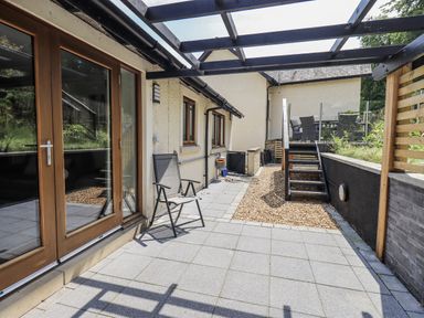An outdoor seating area with a chair and stairs at No 7 in Ambleside