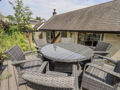 An outdoor seating area with a circular table and chairs at No 7 in Ambleside