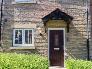 An entrance with a door and window at Driftwood in Filey