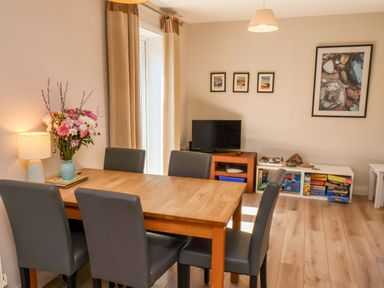 A dining room with a table and chairs at Driftwood in Filey