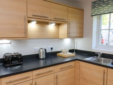 A kitchen with a toaster and kettle at Driftwood in Filey