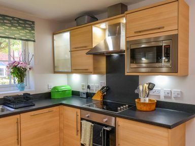 A kitchen with cabinets and modern appliances at Driftwood in Filey