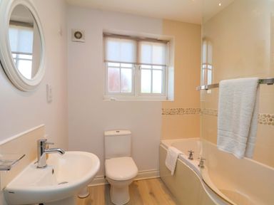 A bathroom with sink and bath tub at Driftwood in Filey