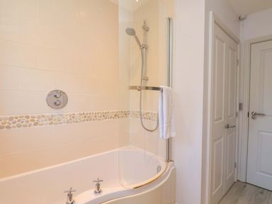 A bathroom with a bathtub and shower at Driftwood in Filey
