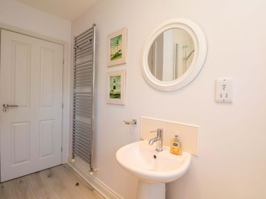 A bathroom with a sink and towel radiator at Driftwood in Filey