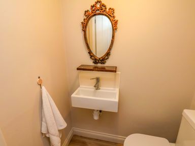 A bathroom with a sink and mirror at Driftwood in Filey