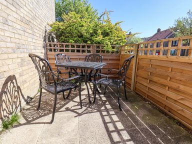 A small outdoor area with a table and chairs at Driftwood in Filey