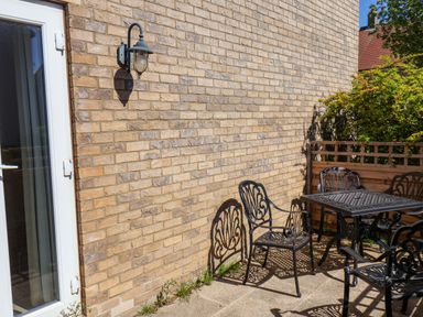 A patio with table and chairs at Driftwood in Filey