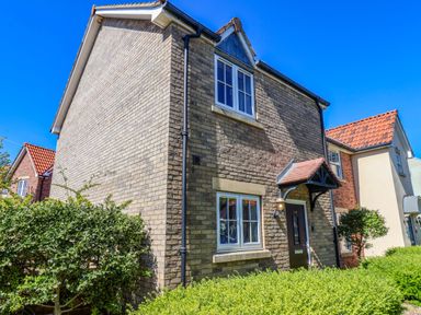 A house with multiple windows and a door at Driftwood in Filey