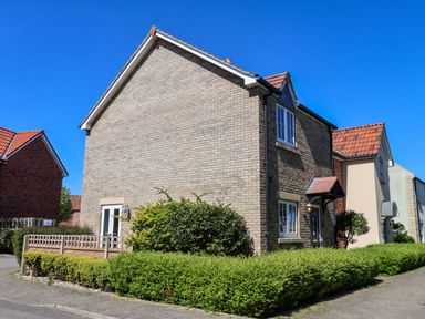 A house with a garden and blue sky at Driftwood in Filey