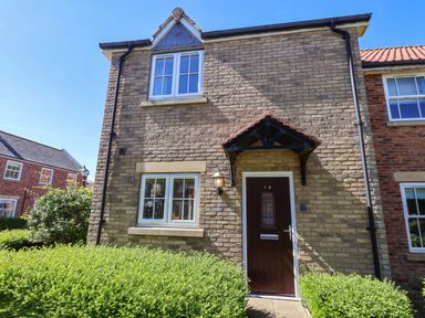 A house exterior featuring a front door and windows at Driftwood Filey
